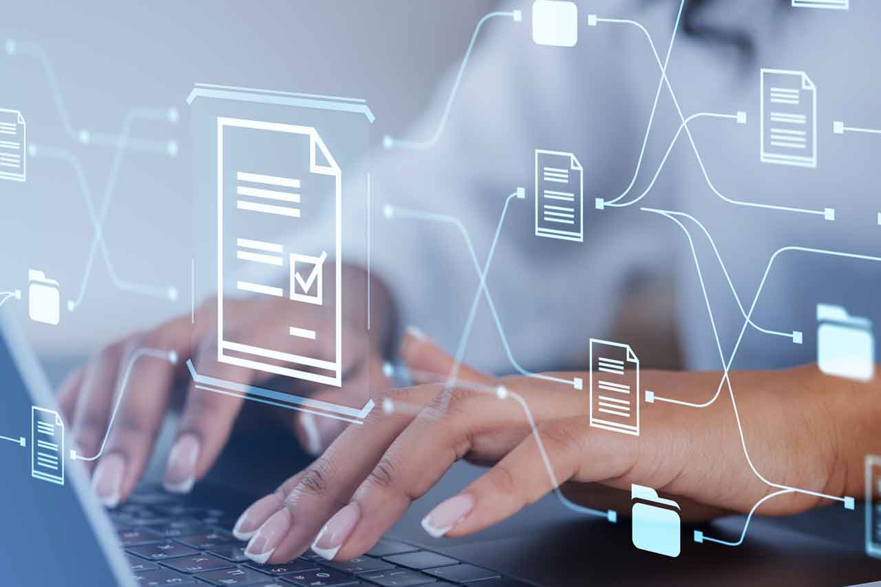 Hands typing on a laptop screen